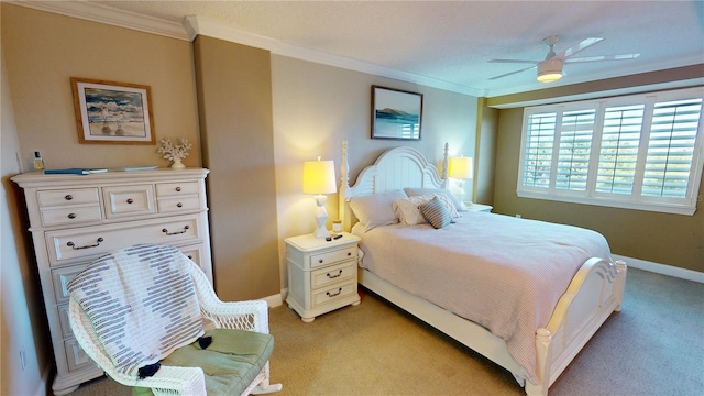 carpeted bedroom with ceiling fan and crown molding