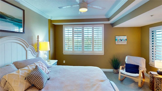 carpeted bedroom with ceiling fan, a textured ceiling, and crown molding