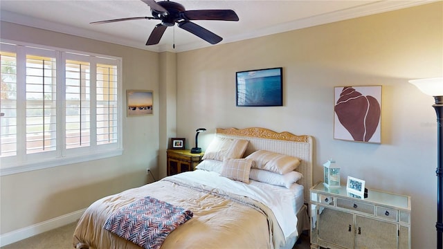 carpeted bedroom featuring ornamental molding and ceiling fan