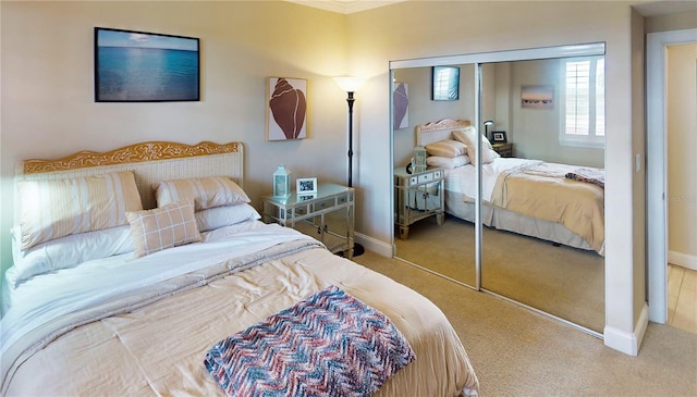 bedroom featuring carpet, ornamental molding, and a closet