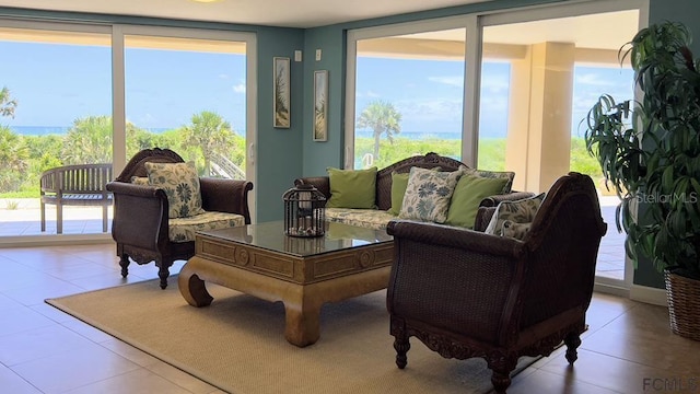 interior space featuring a water view, light tile patterned floors, and a wealth of natural light