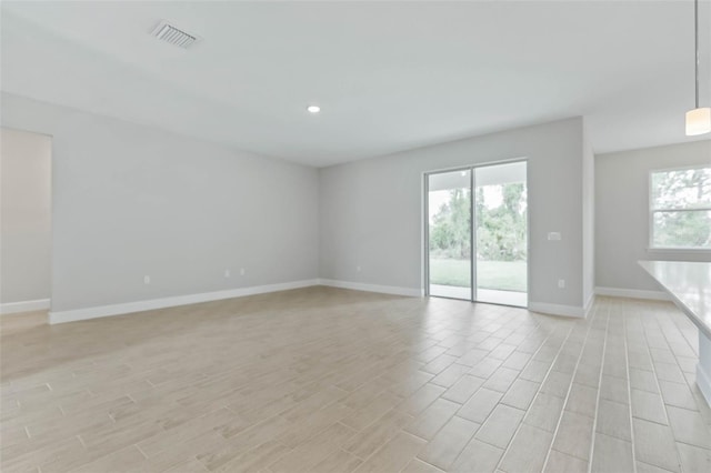 spare room with light hardwood / wood-style flooring and a wealth of natural light