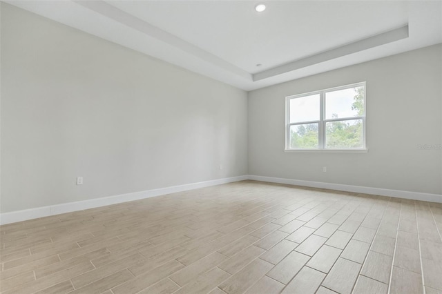 empty room with a raised ceiling