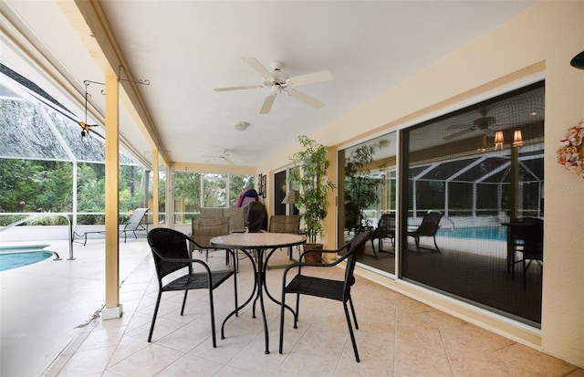 sunroom / solarium featuring a wealth of natural light, a pool, and ceiling fan