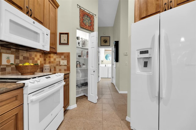 kitchen featuring white appliances, decorative backsplash, and light tile patterned floors