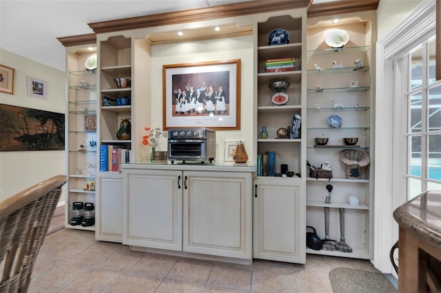 bar featuring white cabinetry, plenty of natural light, and light tile patterned floors