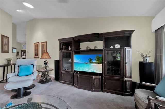 carpeted living room with vaulted ceiling