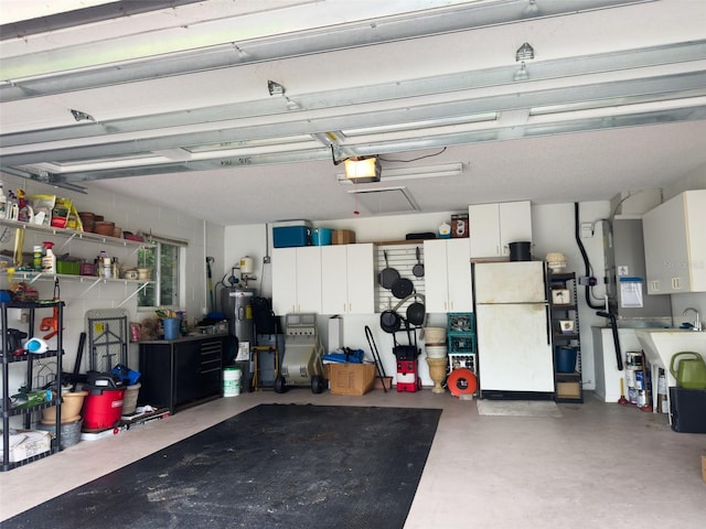 garage with a garage door opener, water heater, and white fridge