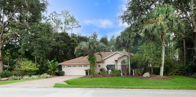 view of front of house featuring a garage and a front lawn