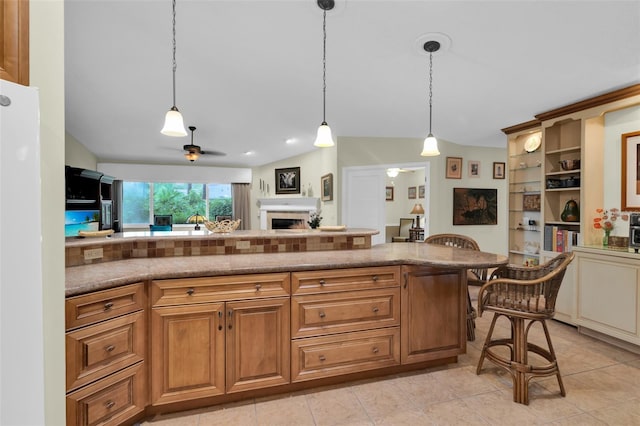 kitchen featuring a kitchen breakfast bar, lofted ceiling, decorative light fixtures, and ceiling fan