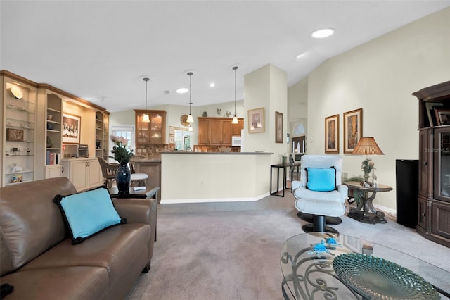 carpeted living room with lofted ceiling and built in features