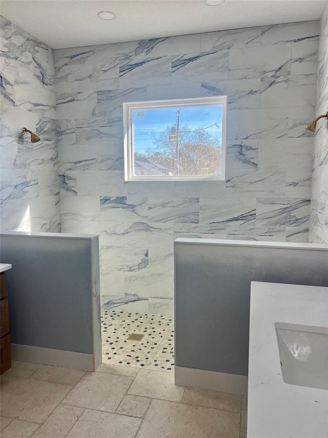 bathroom featuring walk in shower and vanity