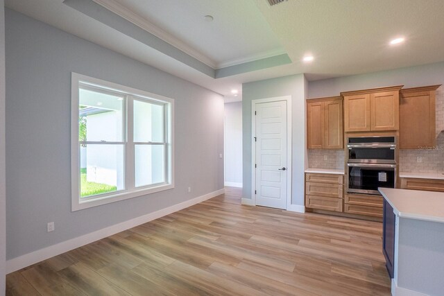 72 Flemingwood Ln, Palm Coast, FL 32137 - kitchen featuring stainless steel double oven, ornamental molding, backsplash, light countertops, and recessed lighting