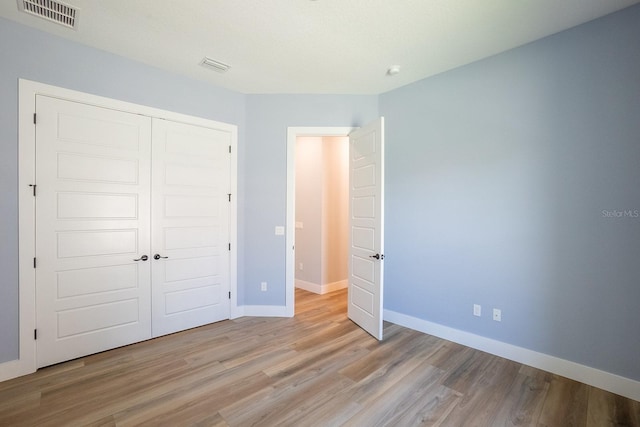 72 Flemingwood Ln, Palm Coast, FL 32137 - unfurnished bedroom featuring wood finished floors, a closet, and baseboards