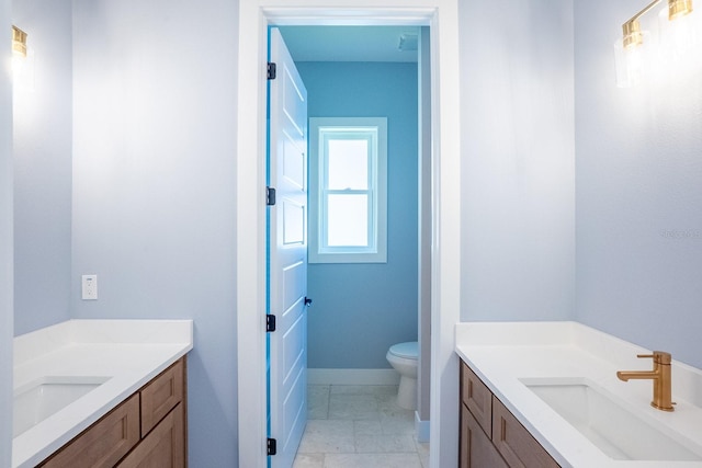 72 Flemingwood Ln, Palm Coast, FL 32137 - full bath with two vanities, toilet, baseboards, and marble finish flooring