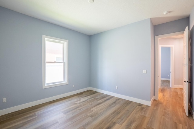 72 Flemingwood Ln, Palm Coast, FL 32137 - unfurnished room featuring light wood finished floors, baseboards, and a smoke detector