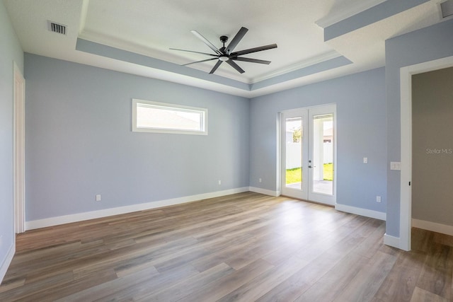 72 Flemingwood Ln, Palm Coast, FL 32137 - spare room featuring a raised ceiling, a ceiling fan, french doors, wood finished floors, and baseboards