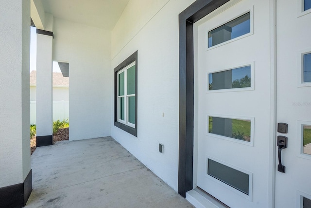 72 Flemingwood Ln, Palm Coast, FL 32137 - entrance to property with stucco siding and a patio area