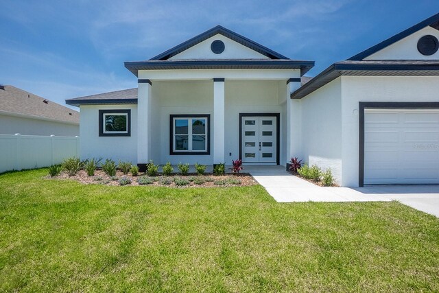 72 Flemingwood Ln, Palm Coast, FL 32137 - view of front of home with stucco siding and a garage