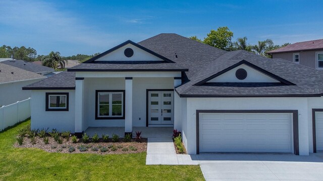72 Flemingwood Ln, Palm Coast, FL 32137 - view of front of home with a shingled roof, an attached garage, concrete driveway, a front lawn, and stucco siding