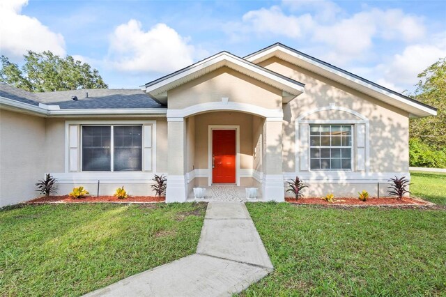 ranch-style home featuring a front yard