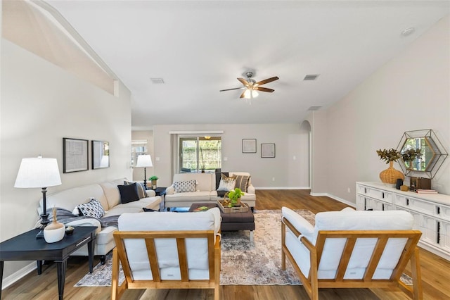 living room featuring ceiling fan and light hardwood / wood-style floors