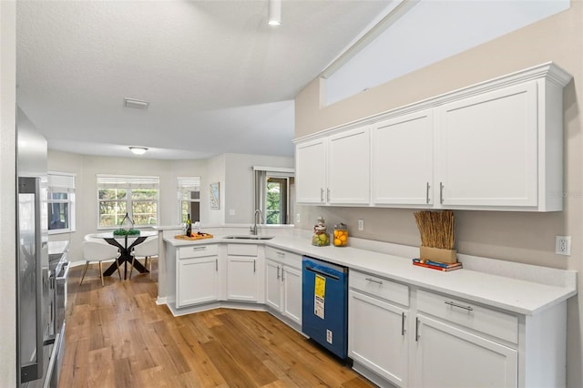 kitchen with white cabinets, dishwasher, and a healthy amount of sunlight