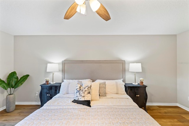 bedroom with ceiling fan and wood-type flooring