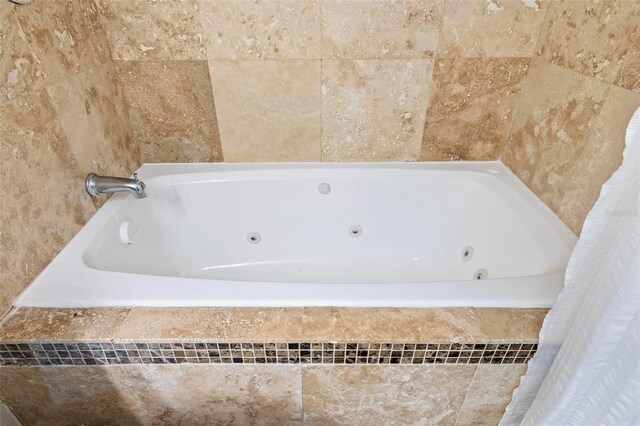 bathroom with a relaxing tiled tub