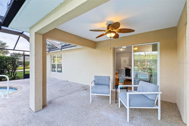 view of patio with a lanai and ceiling fan