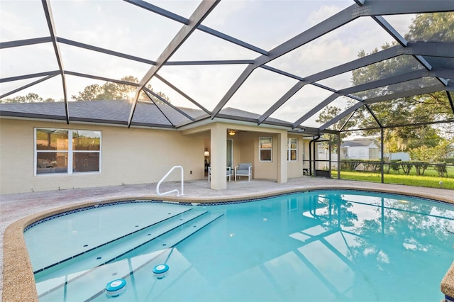 view of swimming pool featuring a lanai and a patio area