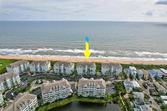 bird's eye view featuring a view of the beach and a water view