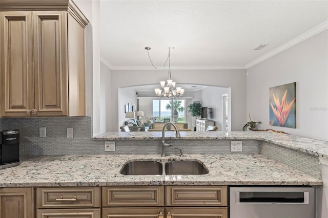 kitchen with light stone counters, a notable chandelier, crown molding, and sink