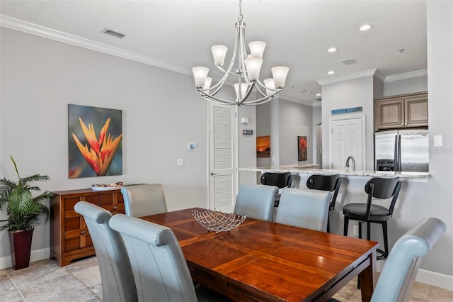 tiled dining area featuring crown molding, sink, and a chandelier