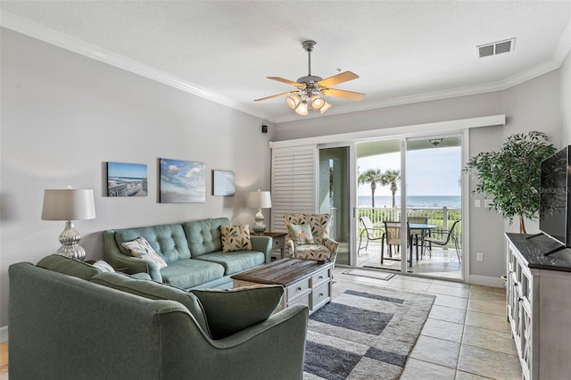 living room featuring a textured ceiling, ornamental molding, and ceiling fan