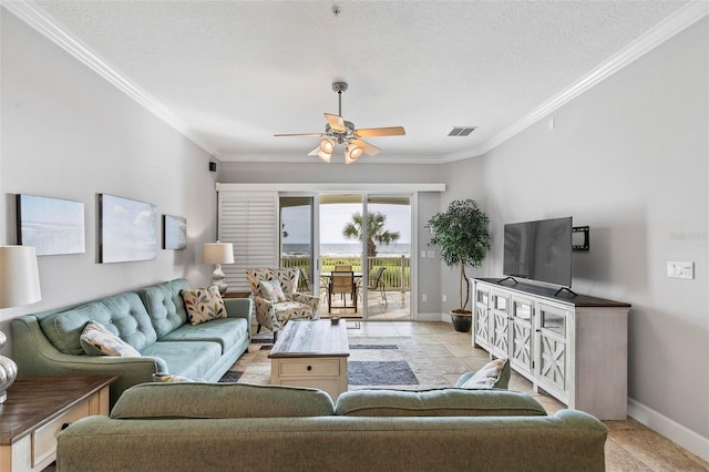 living room with ceiling fan, a textured ceiling, crown molding, and light tile patterned floors