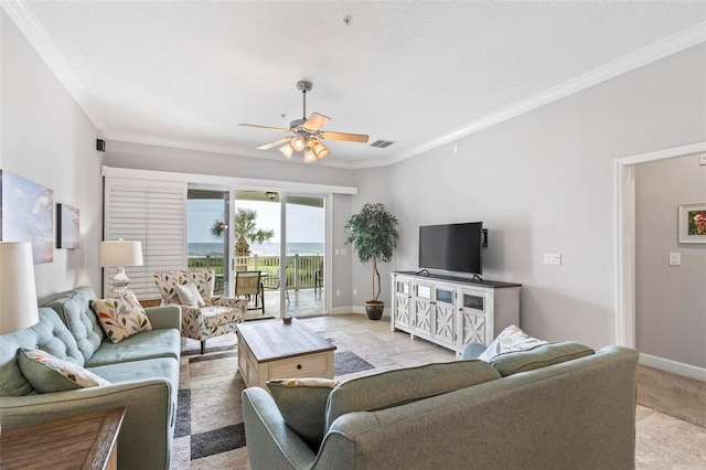 living room with ceiling fan, a textured ceiling, crown molding, and light carpet