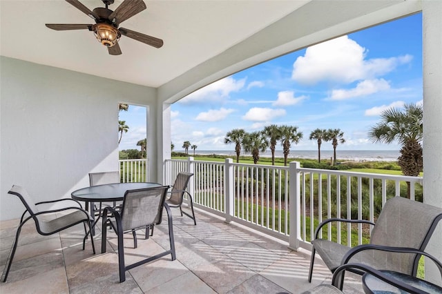 balcony with a water view and ceiling fan