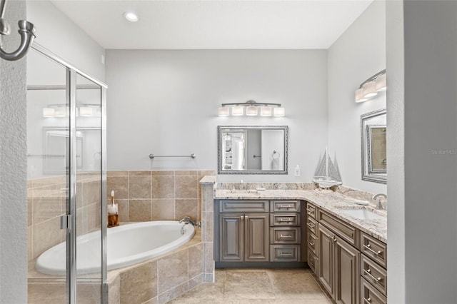 bathroom featuring independent shower and bath and vanity