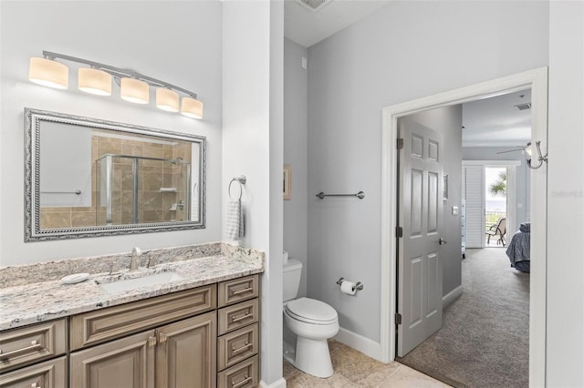 bathroom featuring walk in shower, vanity, toilet, and tile patterned floors