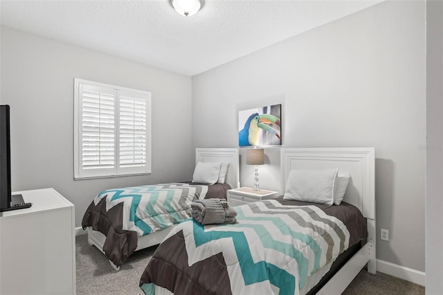 carpeted bedroom featuring a textured ceiling