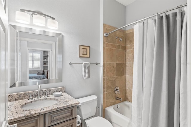 full bathroom featuring shower / bath combo with shower curtain, vanity, and toilet