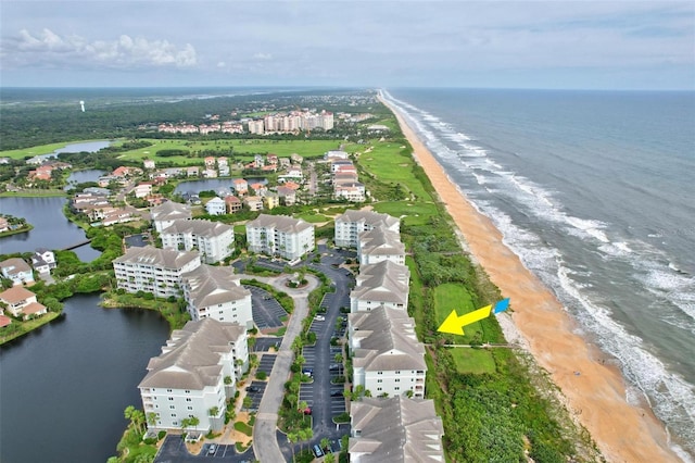 bird's eye view featuring a water view and a beach view