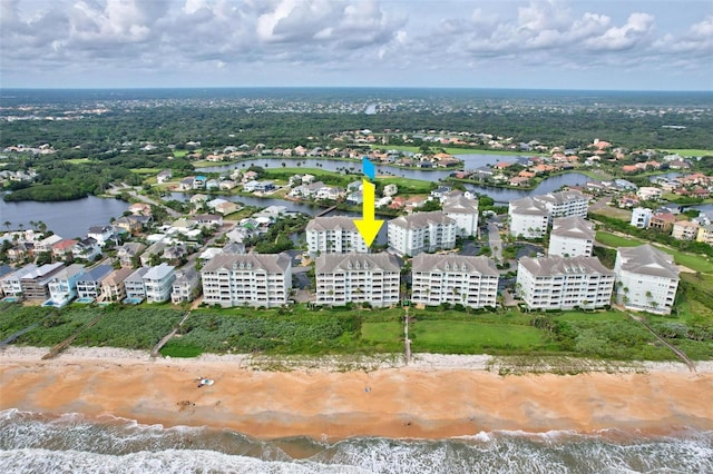 aerial view with a water view and a view of the beach