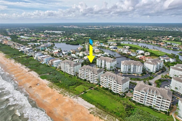 drone / aerial view featuring a water view and a beach view