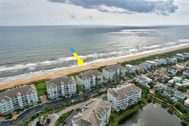 bird's eye view with a water view and a beach view