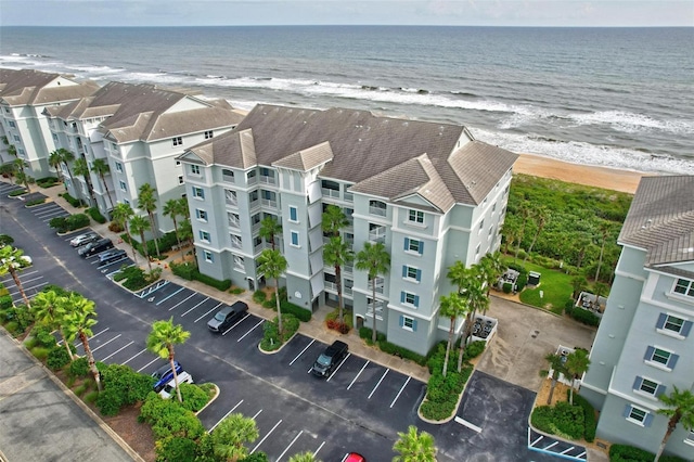 bird's eye view with a water view and a beach view