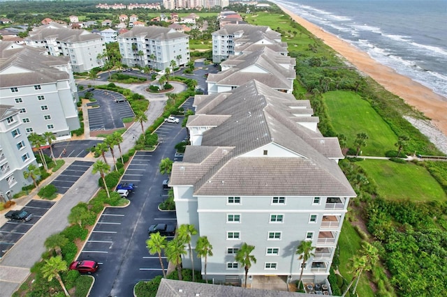 drone / aerial view with a beach view and a water view