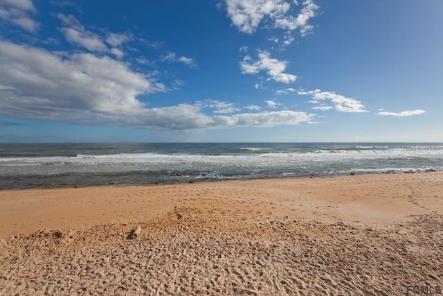 view of water feature with a beach view