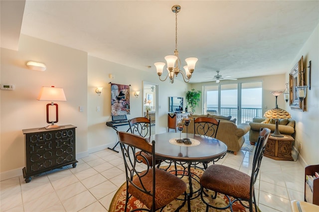 tiled dining room with ceiling fan with notable chandelier